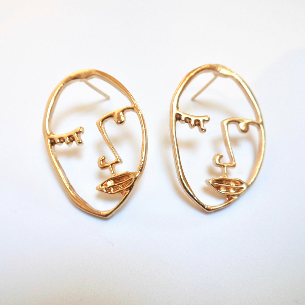 gold coloured face earrings