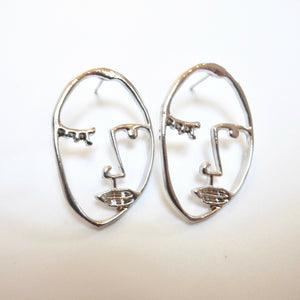 Silver coloured face earrings